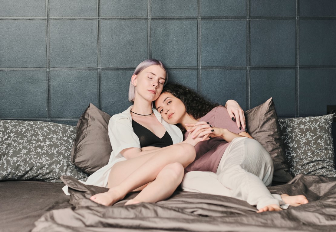 Dve polysexuálne ženy ležia v posteli